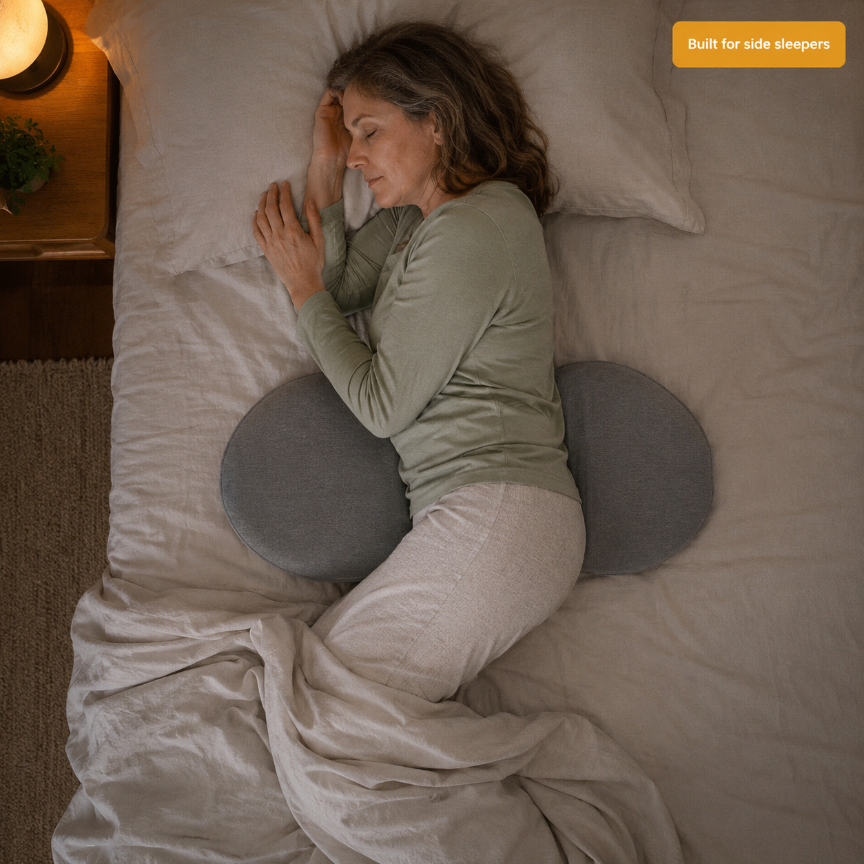 Side sleeper with NightLift supporting her waist — top view