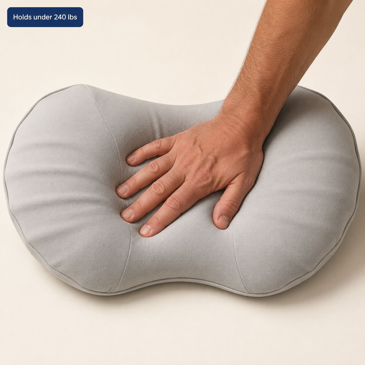 Hand pressing into SlowCore slow-rebound foam — holds under 240 lbs